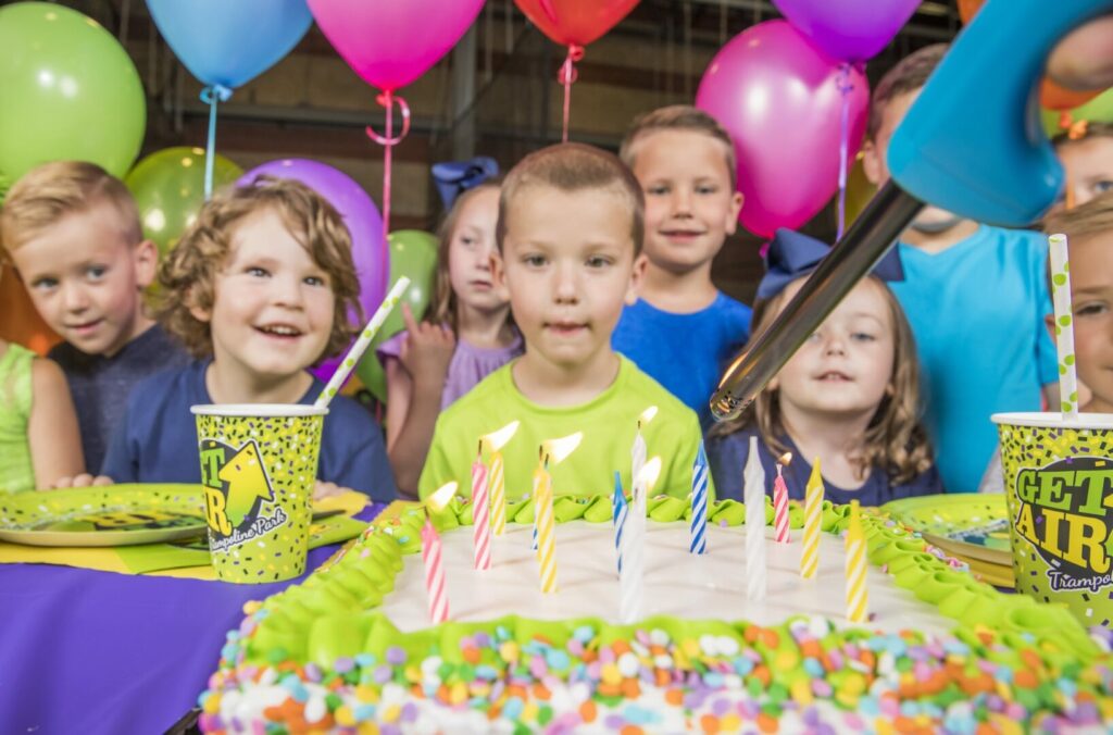 Children gathered around a birthday cake