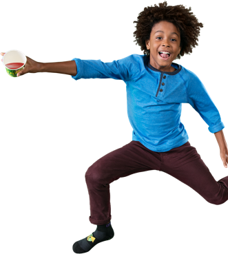 Boy jumping with confetti and purple background.