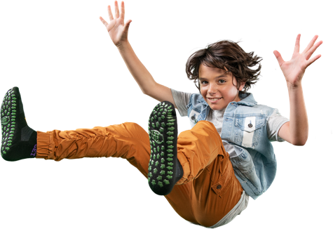 Boy jumping with confetti and yellow background.