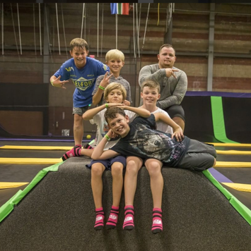 Group of boys posing at a trampoline park.