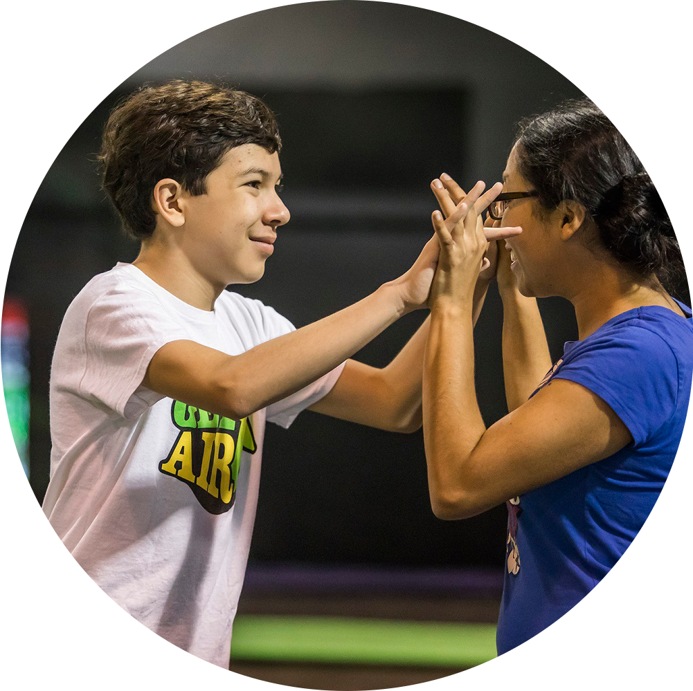 Teen and adult high-fiving.