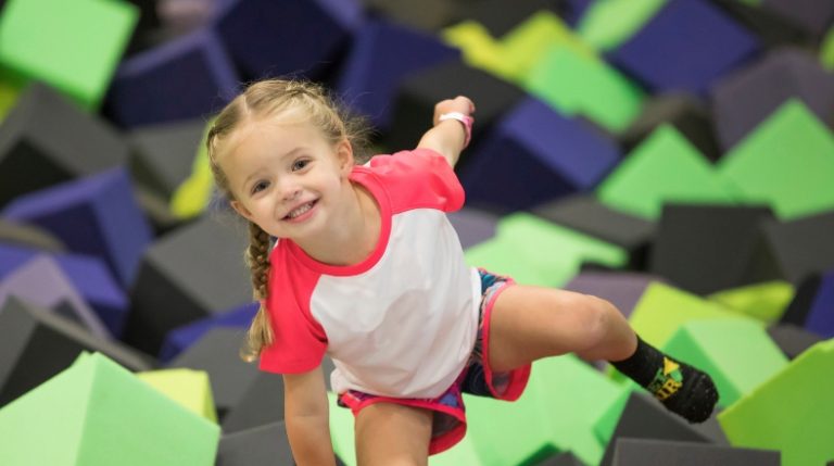 Smiling girl in a foam pit.