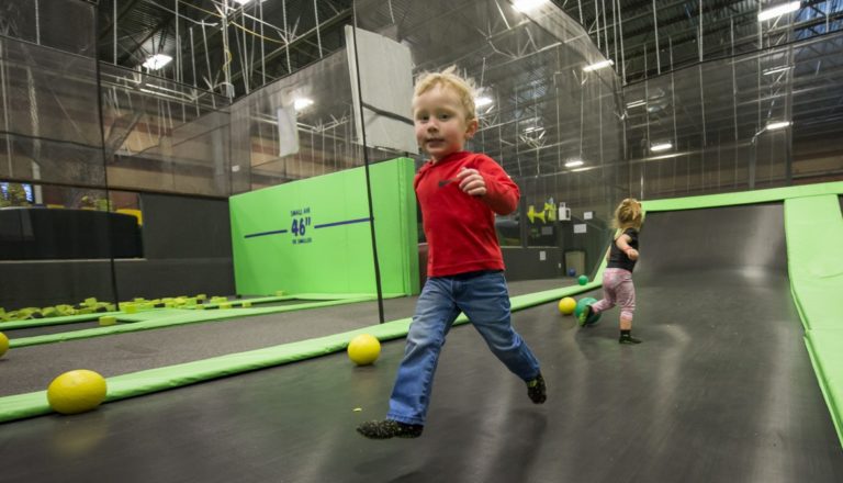 Two toddlers playing on trampolines at Get Air.