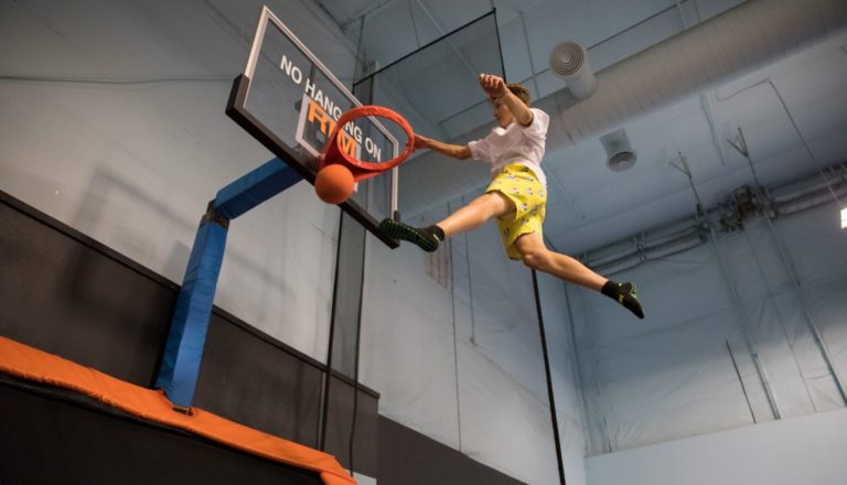 Person in mid-air dunking a basketball.