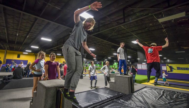 Kids balancing on slacklines.