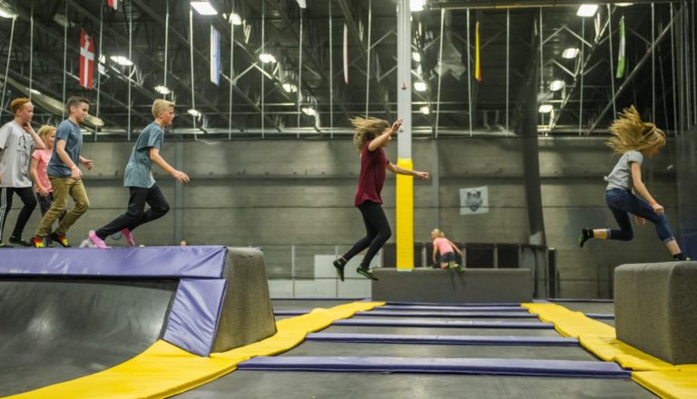 Group of kids jumping on trampolines at Get Air.