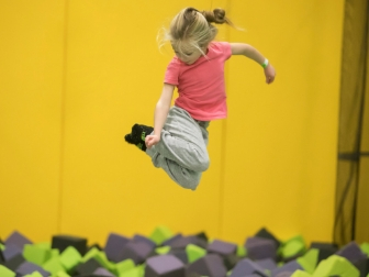 Girl jumping into a foam pit at Get Air.