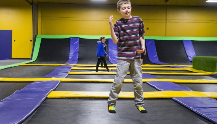 Boy jumping on trampolines.